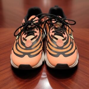 Nike Air Max Torch sneakers featuring a coral orange mesh upper with black wave